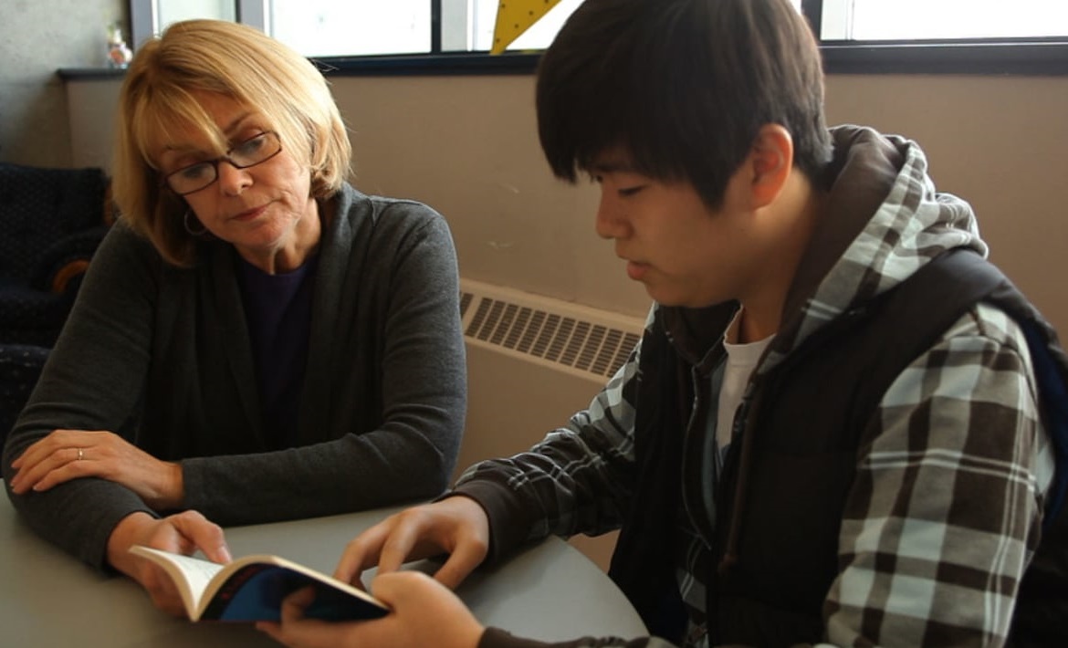 A tutor helps a student work on some problems.